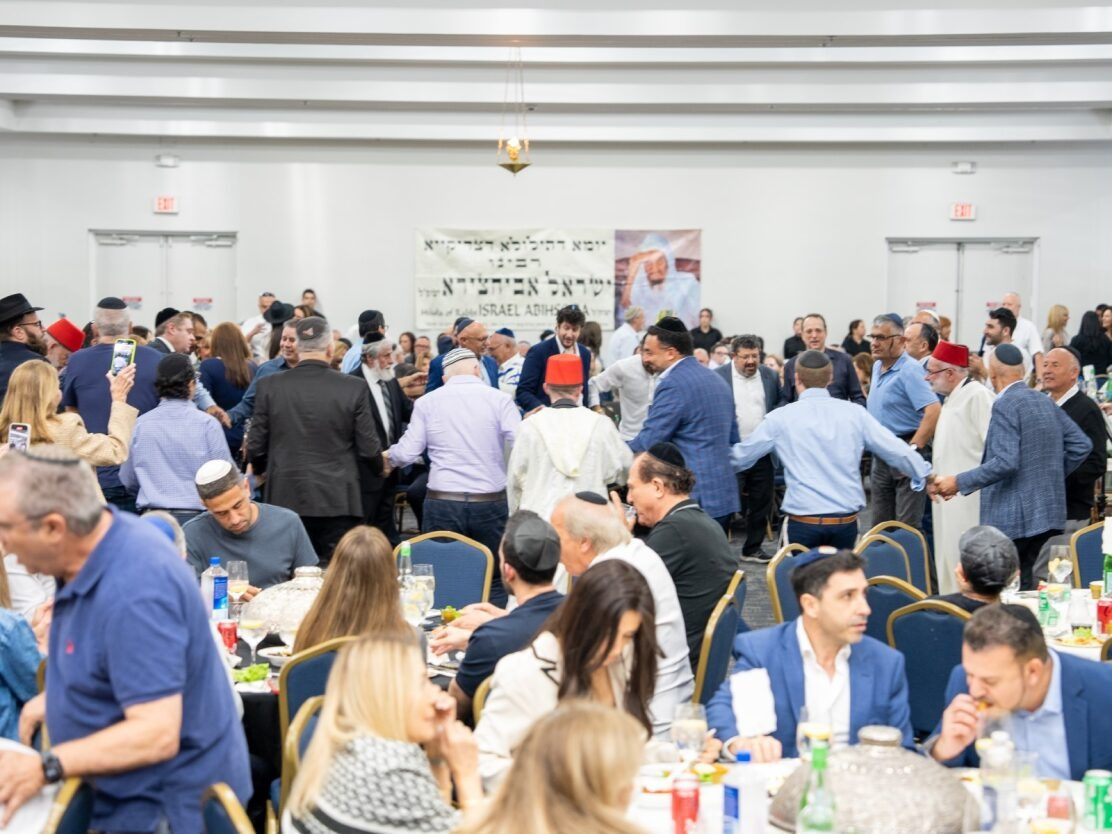 Young families gathered around a Shabbat table